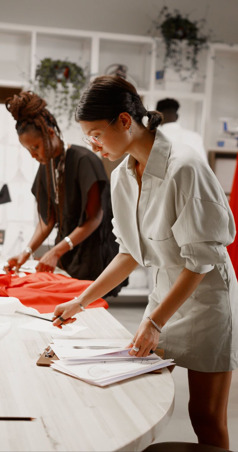 A designer reviewing a pattern at her worktable.